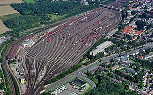 asphalt road, train, rail yard, city, aerial view