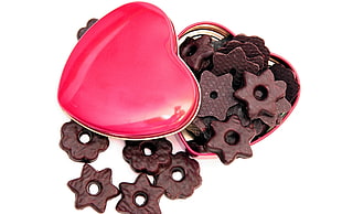 brown chocolate coated biscuits on red heart-shaped container