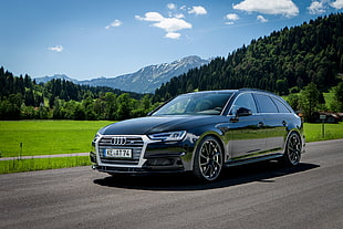 black Audi sedan on the road during daytime