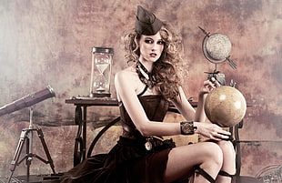 woman wearing black tube dress holding a ball decor