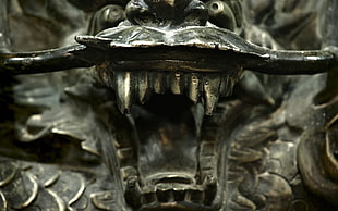 close up photo of gray dragon figurine