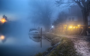 white boat on body of water, mist, lake, house, path