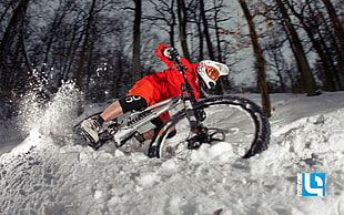 low angle of man riding bike on snow