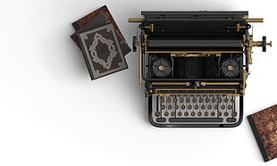 vintage black and brown typewriter near gray book