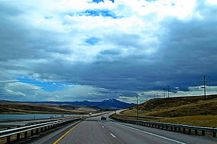 gray street road under white and blue clouds picture during daytime, interstate 15, blackfoot, idaho