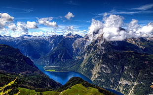 aerial view of green mountains under cloudy sky