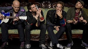 Coldplay sitting on sofa