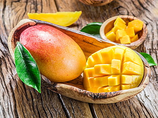 mango fruits on brown wooden bowl