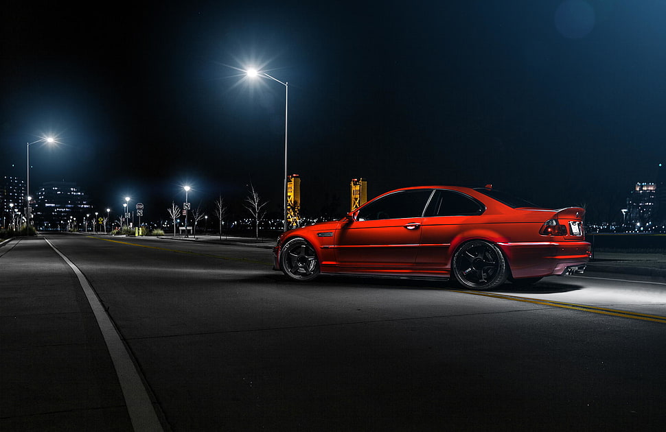 red coupe on gray asphalt road at night time HD wallpaper