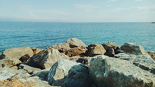 brown boulder lot, sea, rocks, clear sky, nature HD wallpaper