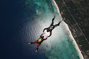 two person performing parachute activity during daytime