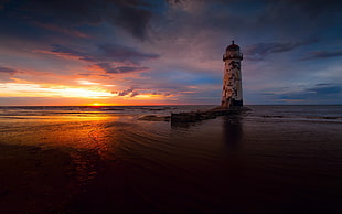 landscape photography of lighthouse during sunset