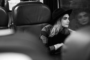 grayscale photo of woman wearing hat and sweater inside vehicle HD wallpaper
