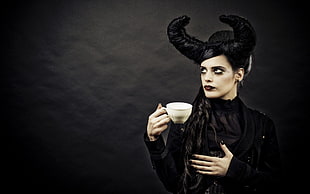 Maleficent holding a cup