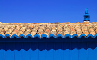 blue building with brown roof under clear blue sky