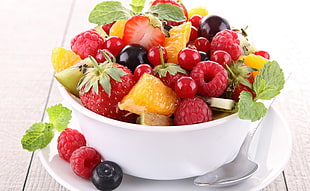 fruit salad in white bowl with spoon