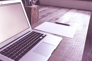 grayscale of MacBook Air in table