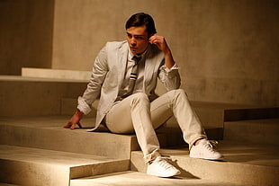 men's white formal suit and pants with pair of white sneakers