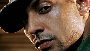 close-up photography of man wearing cap