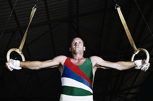 gymnast man wearing green and red tank top