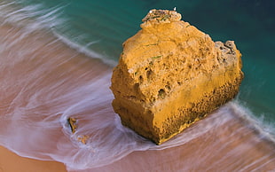 photo of brown rock near seashore