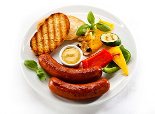 grilled bread with red sliced red and green bell peppers and sausages