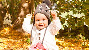 baby wearing gray beanie outdoor HD wallpaper