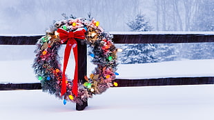 flora wreath with bow on wooden fence during winter