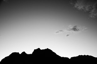 silhouette photo of mountain with white clouds