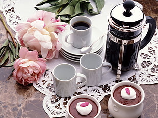 two white ceramic mugs near black thermal carafe