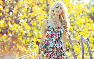 shallow focus photography of woman in multicolored floral spaghetti strap top