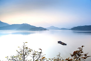 boat on center of body of waqter, sun moon lake, taiwan