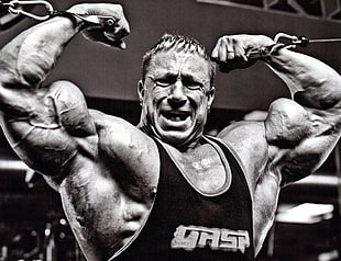 grayscale photo of man using gym equipment portrait photo