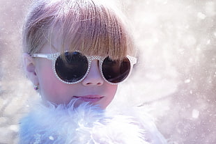selective focus photography of girl wearing sunglasses and white fur top