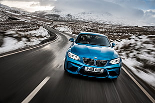 panning photography of blue BMW car