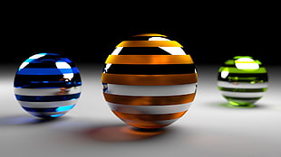 orange, blue, and green stripe marble balls