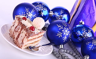 cake in plate beside blue and silver snowflake graphic baubles