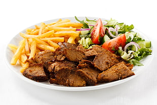 french fries with meat and vegetable salad