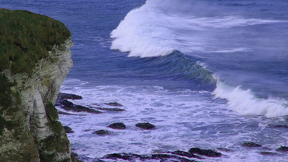 landscape photography of rock mountain near ocean HD wallpaper