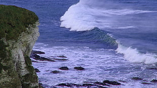 landscape photography of rock mountain near ocean