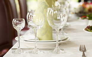 three wine glass on white wooden table