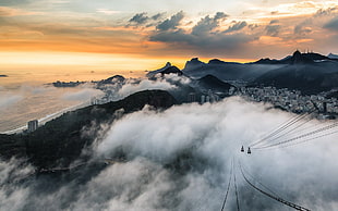 high angle photography of cable with sea of clouds