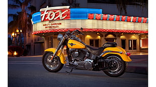 yellow cruiser motorcycle in front of Fox cinema