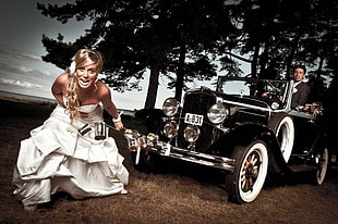 woman in white strapless dress standing in front of vintage car