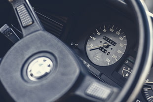 selective focus photography of vehicle analog speedometer