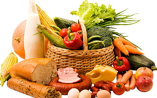 basket of vegetables near cheese, meat, and bread