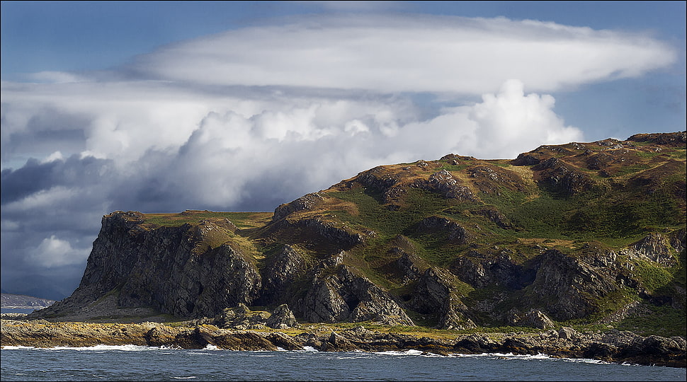 mountain ranges beside sea under white sky HD wallpaper