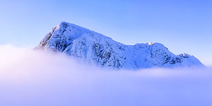 landscape photography of snowy mountain summit above clouds under clear sky during daytime, glencoe, scotland