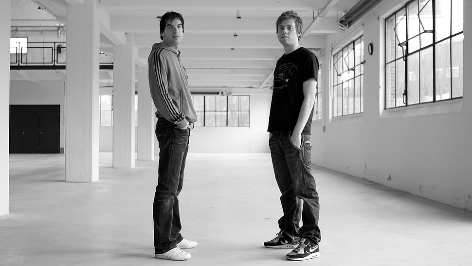 grayscale photo of two men standing HD wallpaper