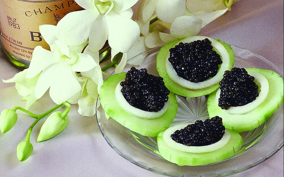 green slice cucumber with black beans on top HD wallpaper